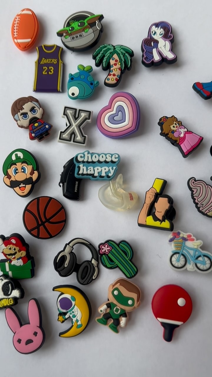 Dozens of charms from the range laid out on a white table