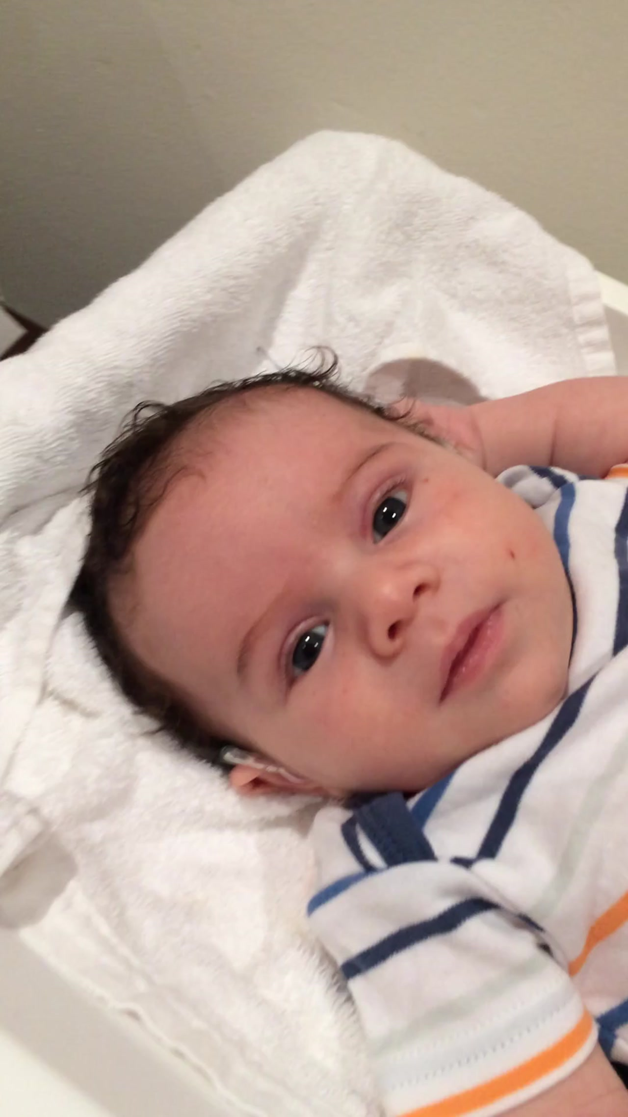 Eden as a baby, wearing a hearing aid